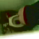 A low-quality voyeur video showing 2 women using a public toilet - as seen from above the stall wall.
